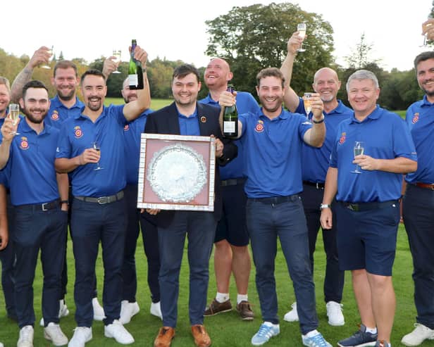 Lawrence Cherry holds the Daily Telegraph Salver after his Hampshire team celebrate winning the South East League Final. Picture by Andrew Griffin.