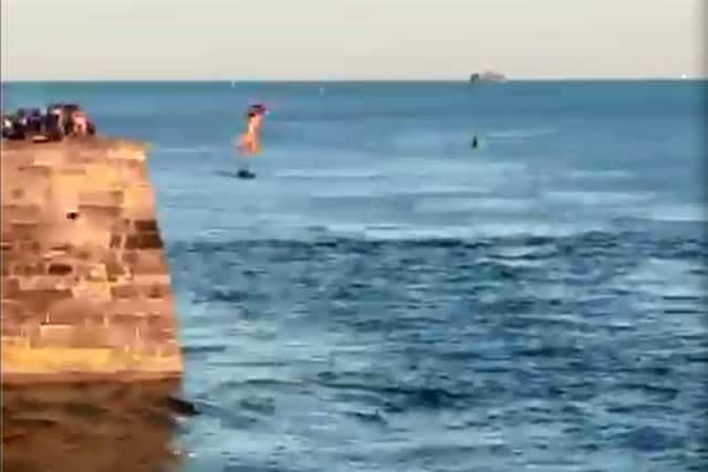 A girl jumps into the Solent tombstoning from Old Portsmouth on June 2 2020.