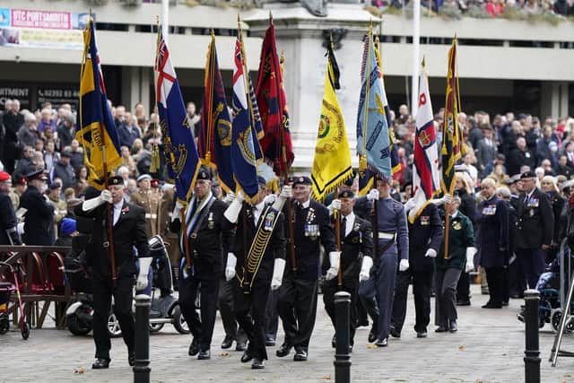 Standard bearers march towards the WWI memorial during the Remembrance Service at the Guildhall Square, in Portsmouth. Picture date: Sunday November 14, 2021.