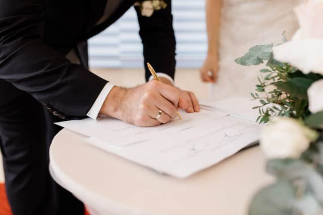 Couple signing marriage documents