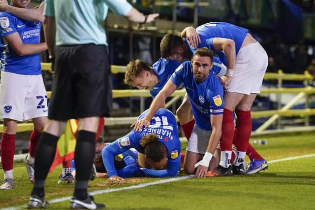 Aiden O'Brien is mobbed by his Pompey team-mates after his late winning capped a sensational fightback. Picture: Jason Brown/ProSportsImages