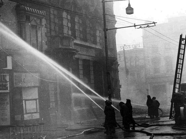 Firefighters fighting a fire at blitzed buildings on the corner of Commercial Road and Edinburgh Road  January 1941.