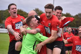 Jon Webb is mobbed after Fareham's penalty shoot-out win against Jersey Bulls. Picture by Paul Proctor