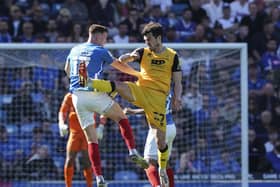 Hayden Carter and John Marquis battle for the ball on the striker's Fratton return.