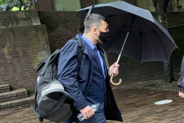 Former PCSO Joshua Fitzjohn leaves Portsmouth Crown Court holding an umbrella having been sentenced for coercive control of his wife.