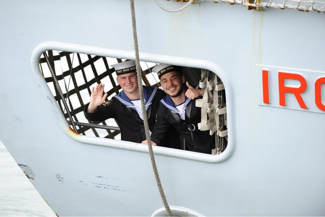 7th July 2016. HMS Iron Duke returned to Portsmouth on Thursday morning and was welcomed by scores of family and friends on the quayside  These two acknowledge family and friends on the quayside from below decks of HMS Iron Duke  Picture by:  Malcolm Wells (160707-1042)