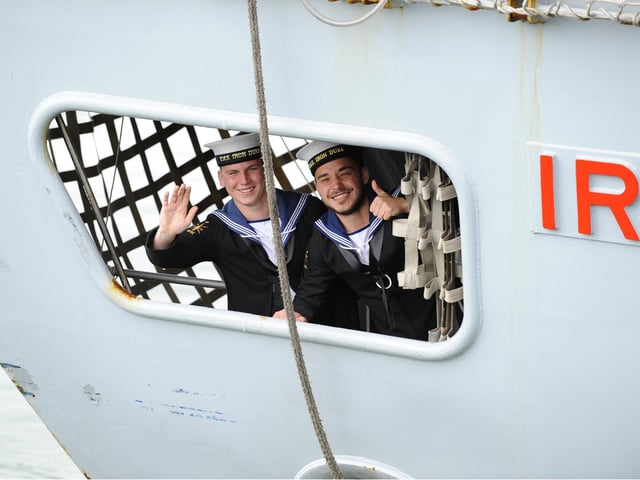 7th July 2016. HMS Iron Duke returned to Portsmouth on Thursday morning and was welcomed by scores of family and friends on the quayside  These two acknowledge family and friends on the quayside from below decks of HMS Iron Duke  Picture by:  Malcolm Wells (160707-1042)