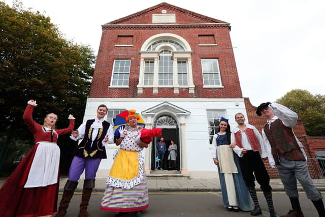 It's behind you! The cast of Beauty and The Beast celebrate at the official opening of the building's restored frontage, Groundlings Theatre, Kent St, Portsea. Cutting the ribbon are Cllr Kirsty Mellor and Cllr Cal Corkery, both of whom are ward councillors for the Charles Dickens ward. The actors are, from left, Megan Crawford, James Edge, Keith Myers, Phoebe Saunders, Adam Boyle and Alasdair Baker
Picture: Chris Moorhouse   (jpns 191021-12)