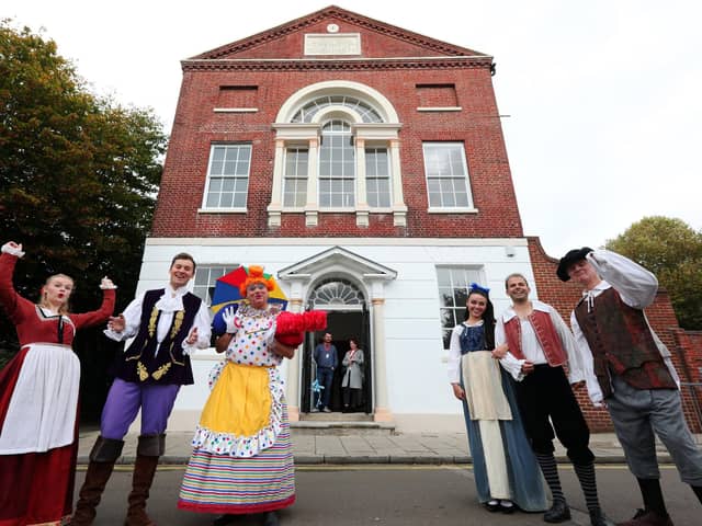 It's behind you! The cast of Beauty and The Beast celebrate at the official opening of the building's restored frontage, Groundlings Theatre, Kent St, Portsea. Cutting the ribbon are Cllr Kirsty Mellor and Cllr Cal Corkery, both of whom are ward councillors for the Charles Dickens ward. The actors are, from left, Megan Crawford, James Edge, Keith Myers, Phoebe Saunders, Adam Boyle and Alasdair Baker
Picture: Chris Moorhouse   (jpns 191021-12)