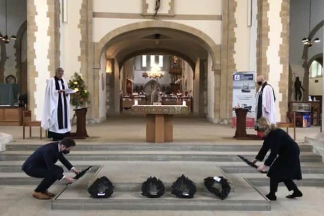 Portsmouth MPs Stephen Morgan, left, and Penny Mordaunt, right, lay wreaths during the annual Seafarers' Service at the city's cathedral. Photo: Portsmouth Cathedral/Facebook