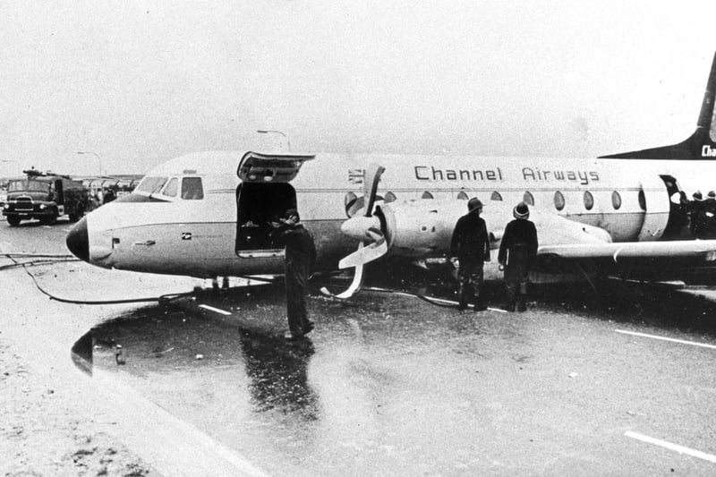 Firefighters at the scene. The Channel Airways aeroplane which ploughed off Portsmouth Airport's grass runway and ended up on Eastern Road in August 1967. No-one was injured.