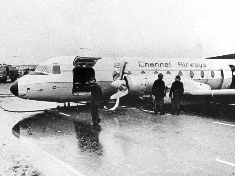 Firefighters at the scene. The Channel Airways aeroplane which ploughed off Portsmouth Airport's grass runway and ended up on Eastern Road in August 1967. No-one was injured.