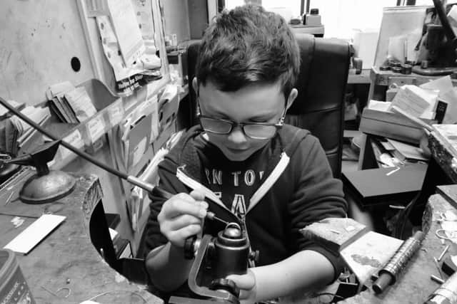 "Young Lucas Catherall diligently repairs a ring at his family's jewellery bench, where his passion