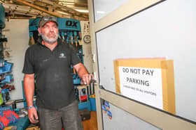 Andy Bottriell from Gosport Plant and Tool Hire with a sign advising his customers they don't have to pay to park for the first hour. Picture: Stuart Martin (220421-7042)