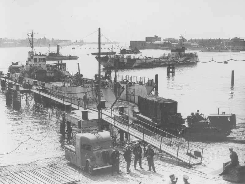 Vehicles embarking onto an LCT (Landing Craft, Tank) at Beach Street, Gosport - where the ferry pier now is. Another LCT waits behind.