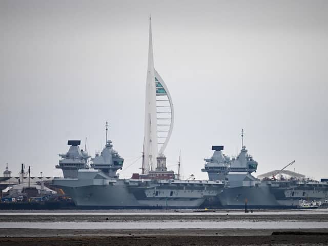 HMS Queen Elizabeth aircraft carrier alongside HMS Prince of Wales, docked in Portsmouth Navy Base, which is to be upgraded. The government has recently confirmed retirement dates for the Queen Elizabeth-class carriers. Photo by Finnbarr Webster/Getty Images