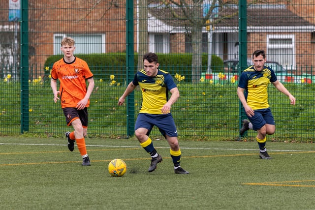 Action from the 2-2 draw between the under-18s of Moneyfields (blue/yellow kit) and AFC Portchester (orange/black kit). Picture: Mike Cooter