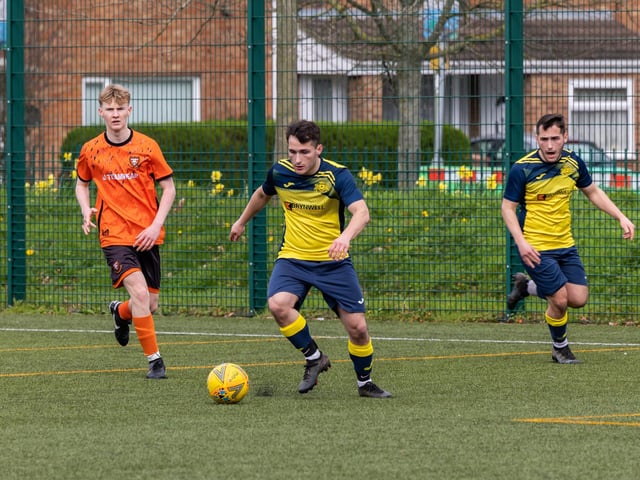 Action from the 2-2 draw between the under-18s of Moneyfields (blue/yellow kit) and AFC Portchester (orange/black kit). Picture: Mike Cooter