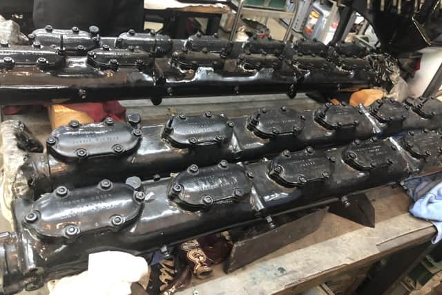 Camshafts from rear engine on workshop bench