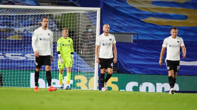 Portsmouth's Jack Whatmough and Portsmouth's Craig MacGillivray look dejected after Brighton and Hove Albion defender Bernardo Fernandes da Silva Junior scores his first goal of the match