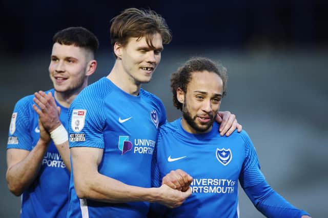 The recalled Marcus Harness celebrates with goalscorer Sean Raggett at the final whistle of Pompey's 4-0 success over Doncaster. Picture: Joe Pepler