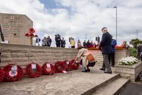 The Portsmouth City Council and Royal British Legion D-Day 75 memorial service on Monday 6th June 2022 at the D-Day Stone, Southsea. Visitors laying the wreath by the D-Day Stone, Southsea.