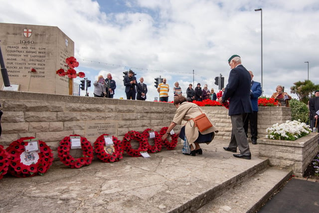 The Portsmouth City Council and Royal British Legion D-Day 75 memorial service on Monday 6th June 2022 at the D-Day Stone, Southsea. Visitors laying the wreath by the D-Day Stone, Southsea.