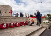 The Portsmouth City Council and Royal British Legion D-Day 75 memorial service on Monday 6th June 2022 at the D-Day Stone, Southsea. Visitors laying the wreath by the D-Day Stone, Southsea.