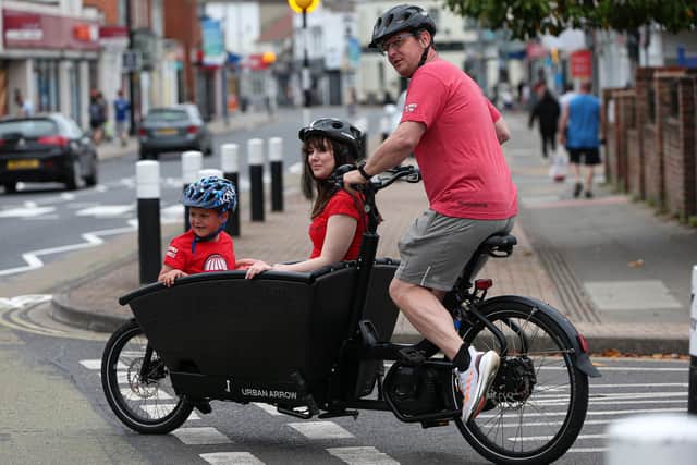 Kevin Watkins pedals his son Max, 7, and Emma Strong in his cargo bike
Picture: Chris Moorhouse (jpns 060621-36)