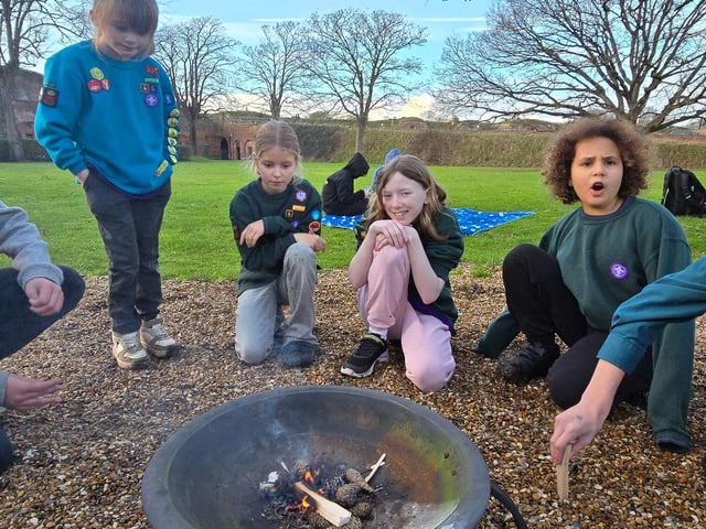 Poppy (13), Poppy (7), Robin (9), Hannah (9), Hannah (9) and Rebecca (12) prepare the fire for S'mores.