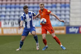 Jack Whatmough tussles with Jamie Proctor of Wigan in their DW Stadium encounter. Picture: Daniel Chesterton/phcimages.com