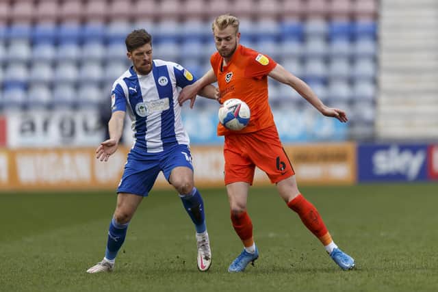 Jack Whatmough tussles with Jamie Proctor of Wigan in their DW Stadium encounter. Picture: Daniel Chesterton/phcimages.com