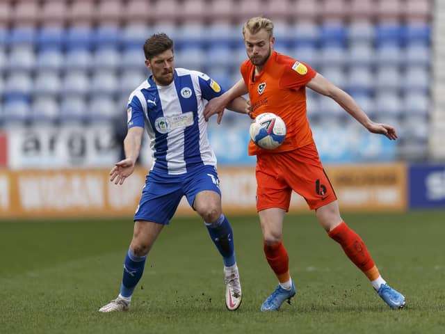 Jack Whatmough tussles with Jamie Proctor of Wigan in their DW Stadium encounter. Picture: Daniel Chesterton/phcimages.com