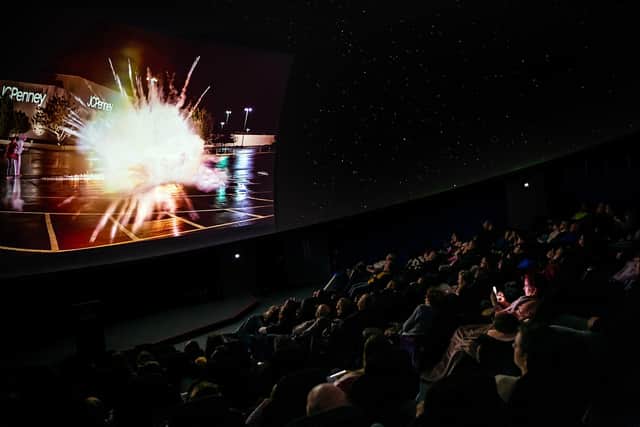 Families enjoying a film screening inside Winchester Science Centre's planetarium.