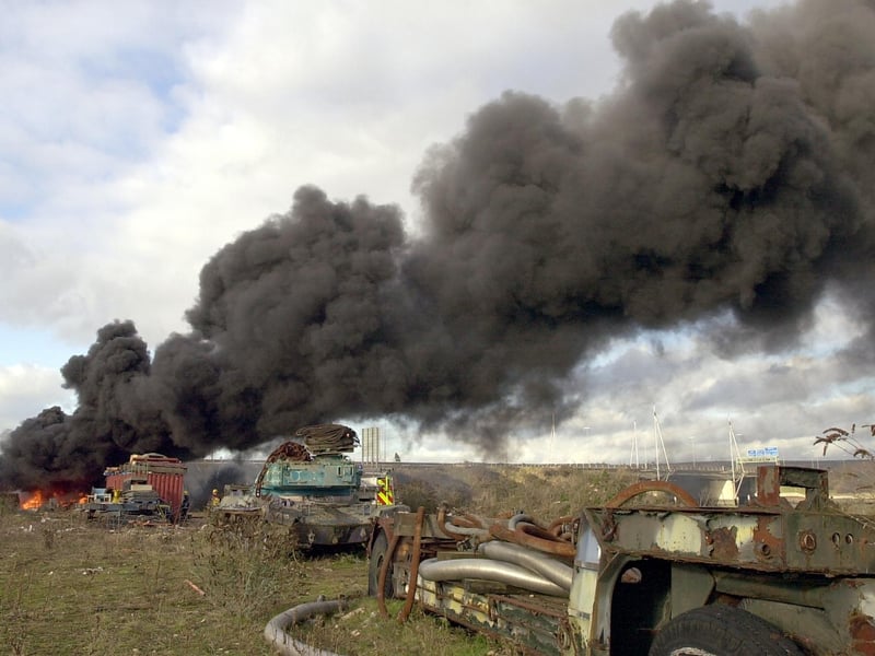 Firefighters at the scene of a fire at Pounds Shipyard - police had to close the M275 that passes above where the fire was located. 3rd January 2005. Picture: Malcolm Wells 050020-139