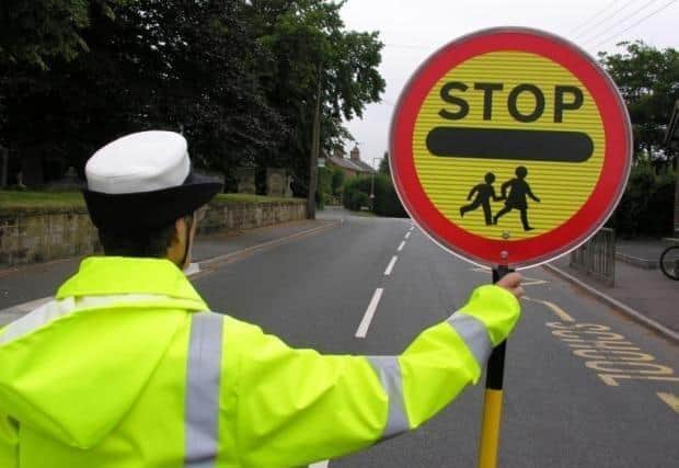 School crossing patrols could be put at risk as a result of measures by Hampshire County Council to save money. Picture for illustrative purposes only