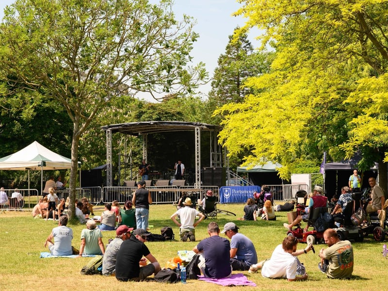 People relaxing and enjoying the gorgeous weather and music.