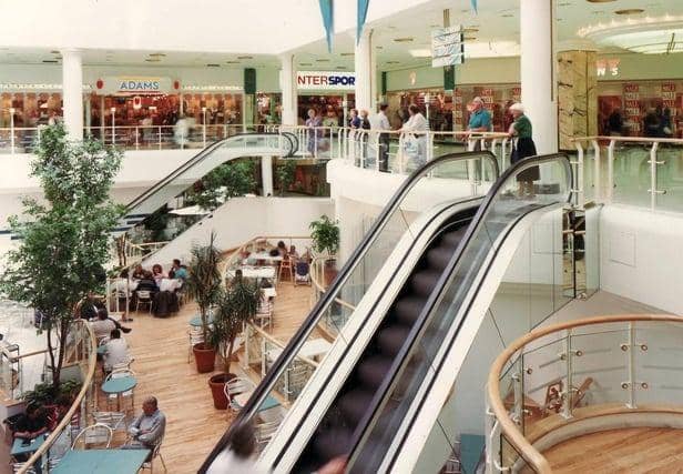 The escalators leading down to the food court, with long-lost shops such as Adams and Intersport on the level above