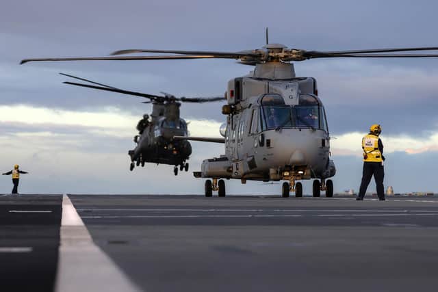 Pictured: Leading Airman Mack hones in the aircraft as an RAF Chinook from 7 Squadron RAF and a Royal Navy Merlin from 846 RNAS drop food supplies to HMS Prince of Wales off the coast of England.