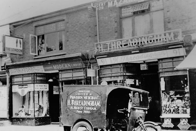 H. Threadingham Grocer and Provision Merchant. Some very old shops in Cosham High Street. Notice the lending library on the left. 
Picture: Courtesy of Mrs Westall