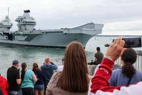 Families watching on as HMS Prince of Wales sails past The Round Tower. Picture: LPhot Edward Jones/Royal Navy.