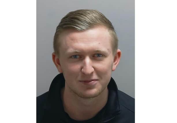 Smirking, Bradley David Young, 24, of Forest End is pictured in custody for stealing almost £200,000 from a care firm. Today he has been jailed for six years.Photo: Hampshire police