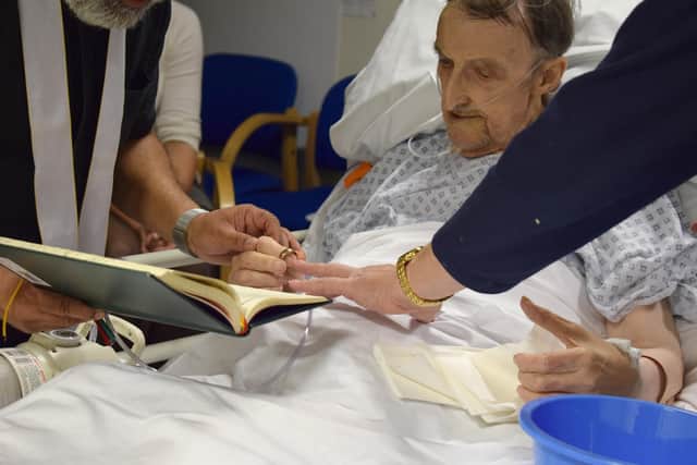 Kim and Peter exchanging rings at their wedding ceremony. Credit: QA Hospital.