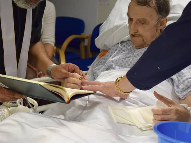 Kim and Peter exchanging rings at their wedding ceremony. Credit: QA Hospital.