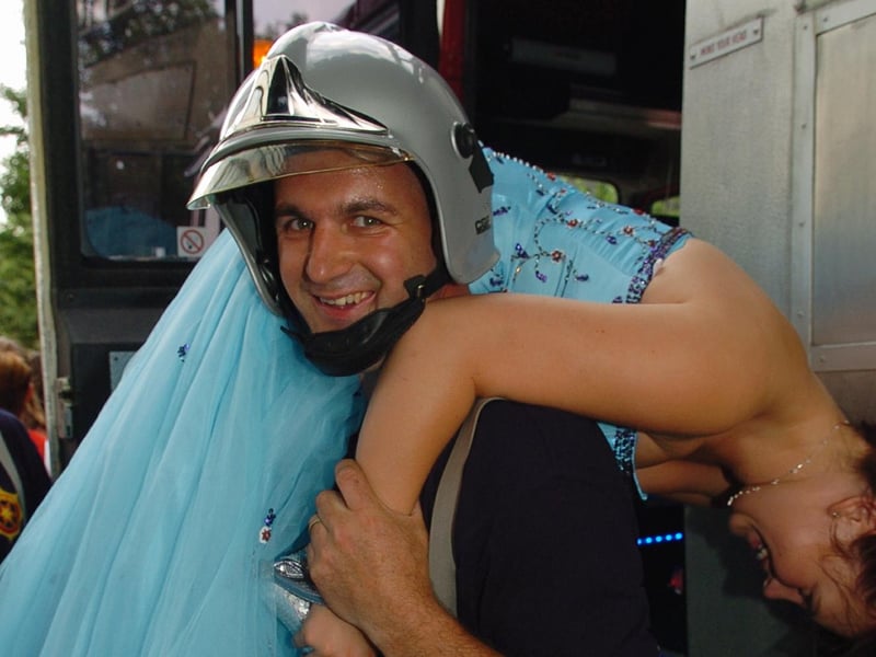 Paul Houghton gives a ' fireman's lift ' to Danielle Grindey (16) at St Edmund's Catholic School's prom at The Marriott Hotel in Portsmouth in July 2006. Picture: (062937-101)