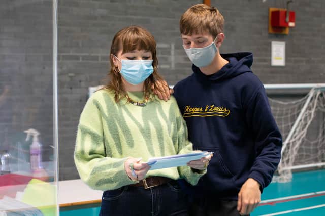A-level results day at Portsmouth College, Portsmouth on 10th August 2021. Pictured: Holly Paine and Reece Renshaw. Picture: Habibur Rahman