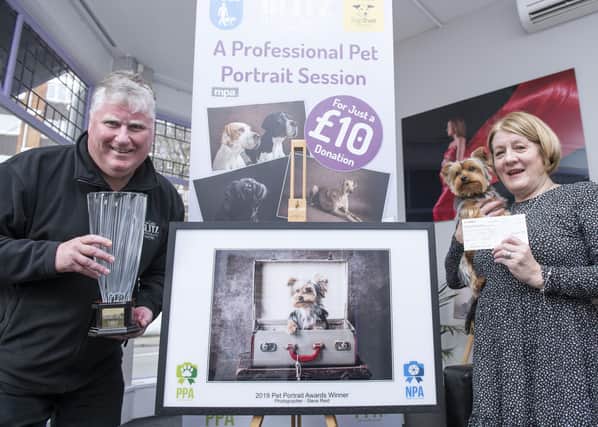 Gosport Photographer Steve Reid (left) with customer Patricia Hume and her Yorkie Myla. This portrait won former News photographer Steve the Pet Portrait Photographer of the Year and the UKPP National Portrait Awards and Patricia a cheque for £1000.