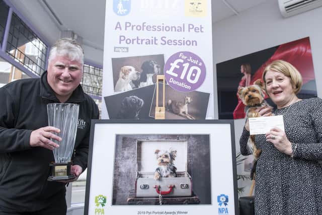Gosport Photographer Steve Reid (left) with customer Patricia Hume and her Yorkie Myla. This portrait won former News photographer Steve the Pet Portrait Photographer of the Year and the UKPP National Portrait Awards and Patricia a cheque for £1000.