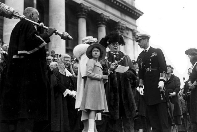 The Queen as an 11-year-old with her father King George VI in Guildhall Square during a visit to Portsmouth in June 1937. The News PP757