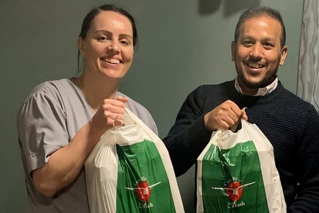 Nurse Vicky Nightingale with Faz Ahmed from The Akash delivering free curries to QA nurses. Picture: Faz Ahmed